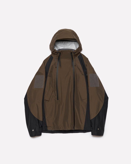 A hooded jacket in brown and black, featuring a zippered front, drawstrings, and textured gray patch panels on the upper arms, displayed against a light gray background.